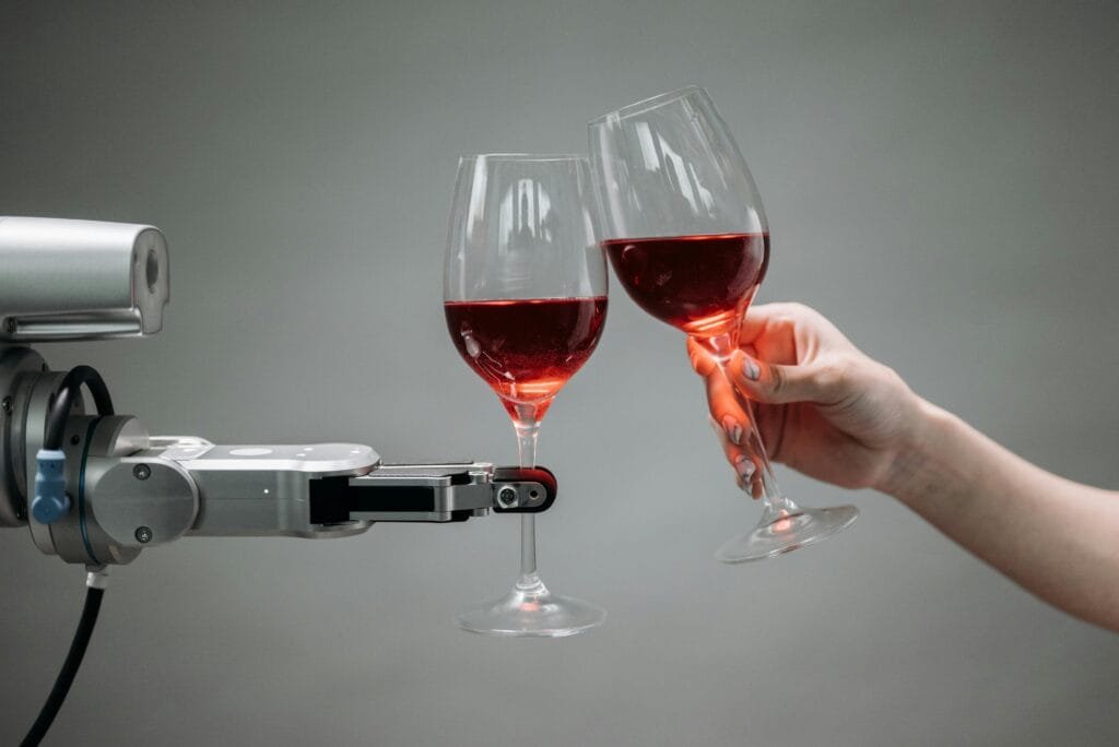 A robot and a human hand clinking glasses of red wine, symbolizing technology and celebration. business process automation